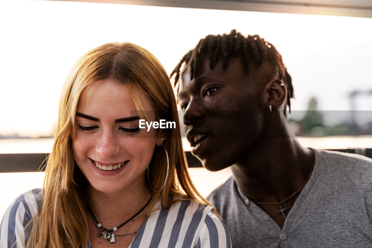 Portrait of an engaged multiethnic couple having fun on summer vacation on a river cruise ship