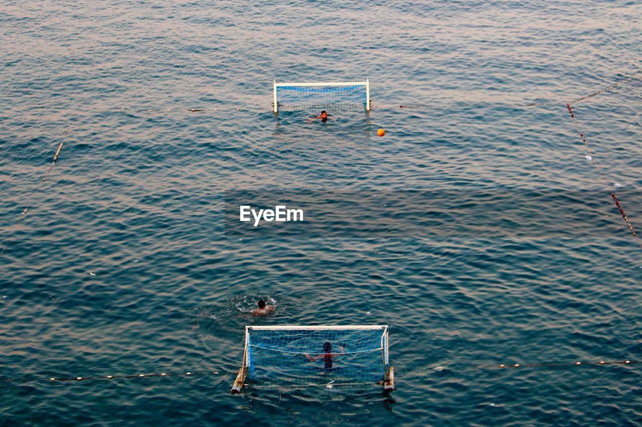 High angle view of people playing water polo at sea