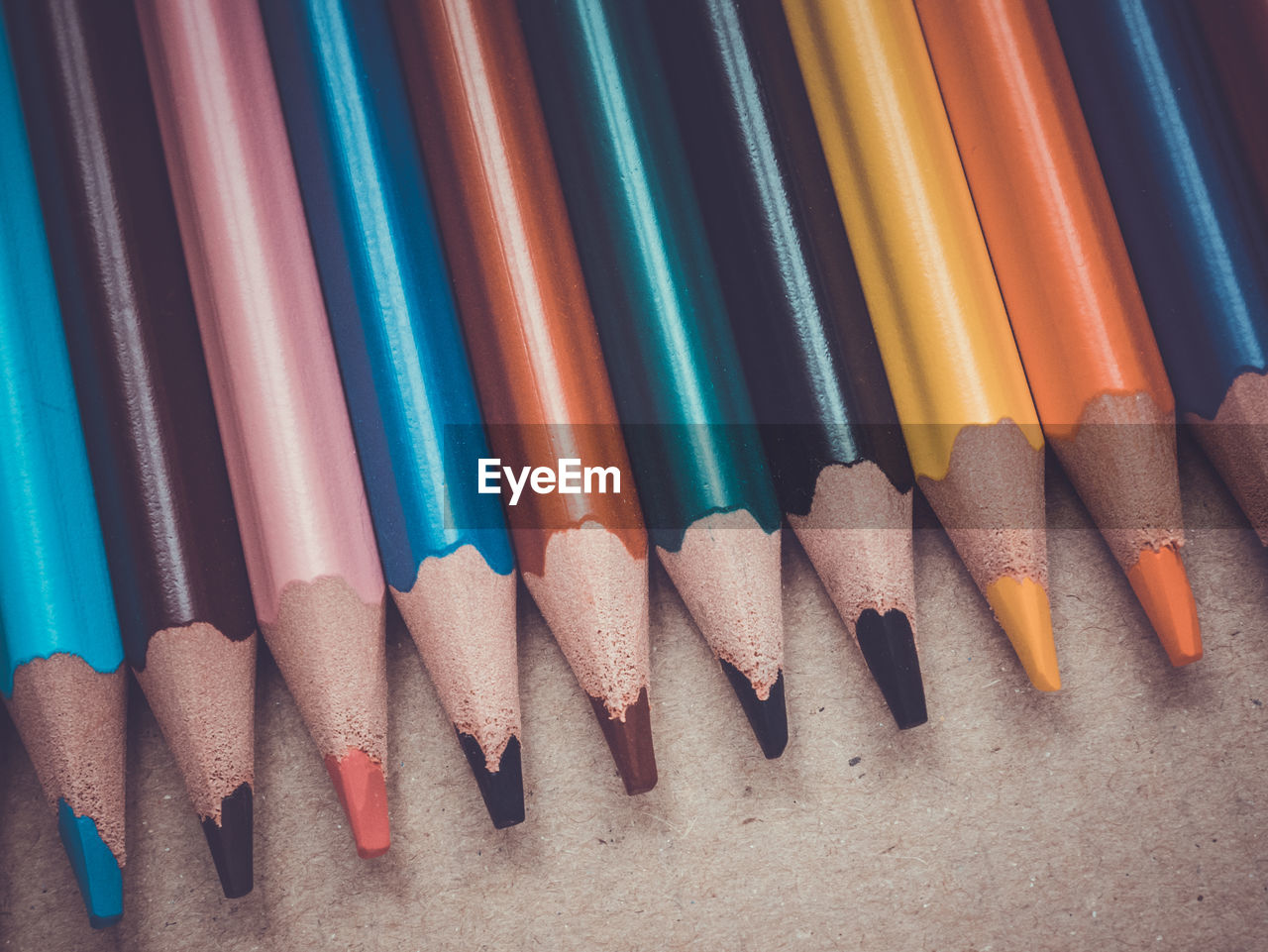 Close-up of colored pencils arranged on table