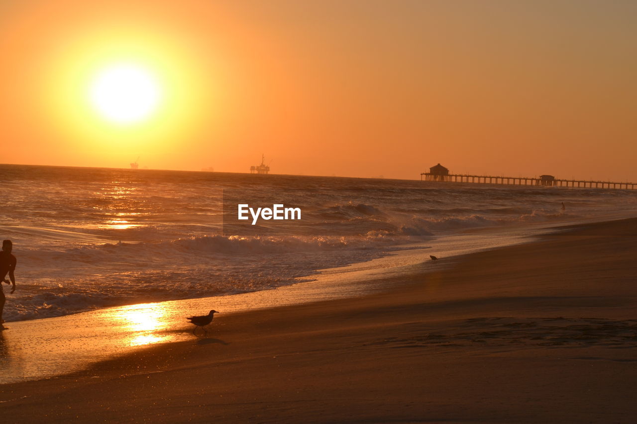 SCENIC VIEW OF SEA AGAINST ORANGE SKY