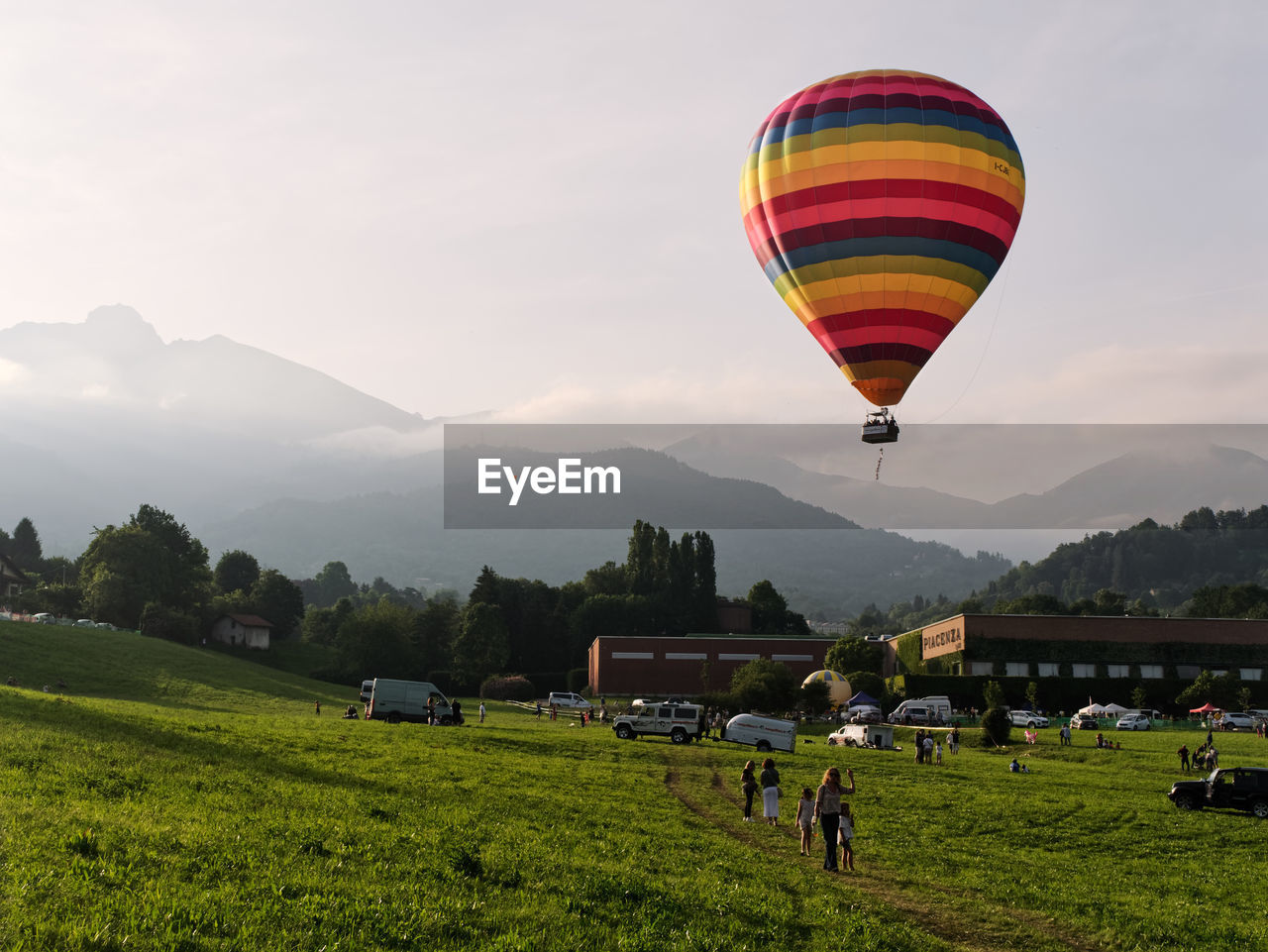 HOT AIR BALLOONS FLYING OVER LAND