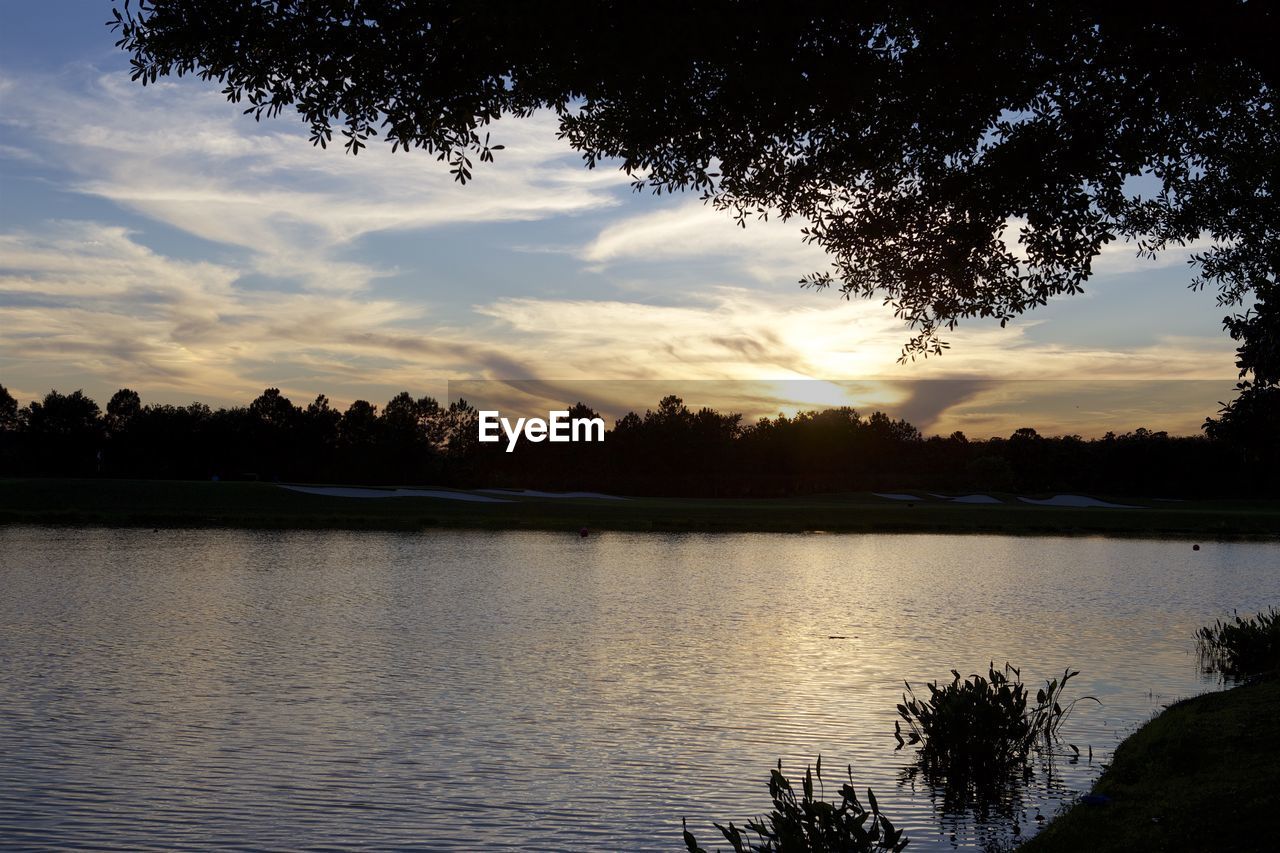 VIEW OF LAKE AGAINST CLOUDY SKY