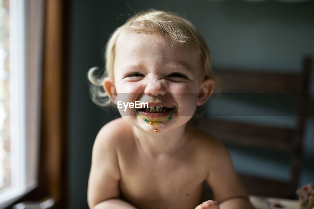 Toddler girl smiling after eating sweet treat
