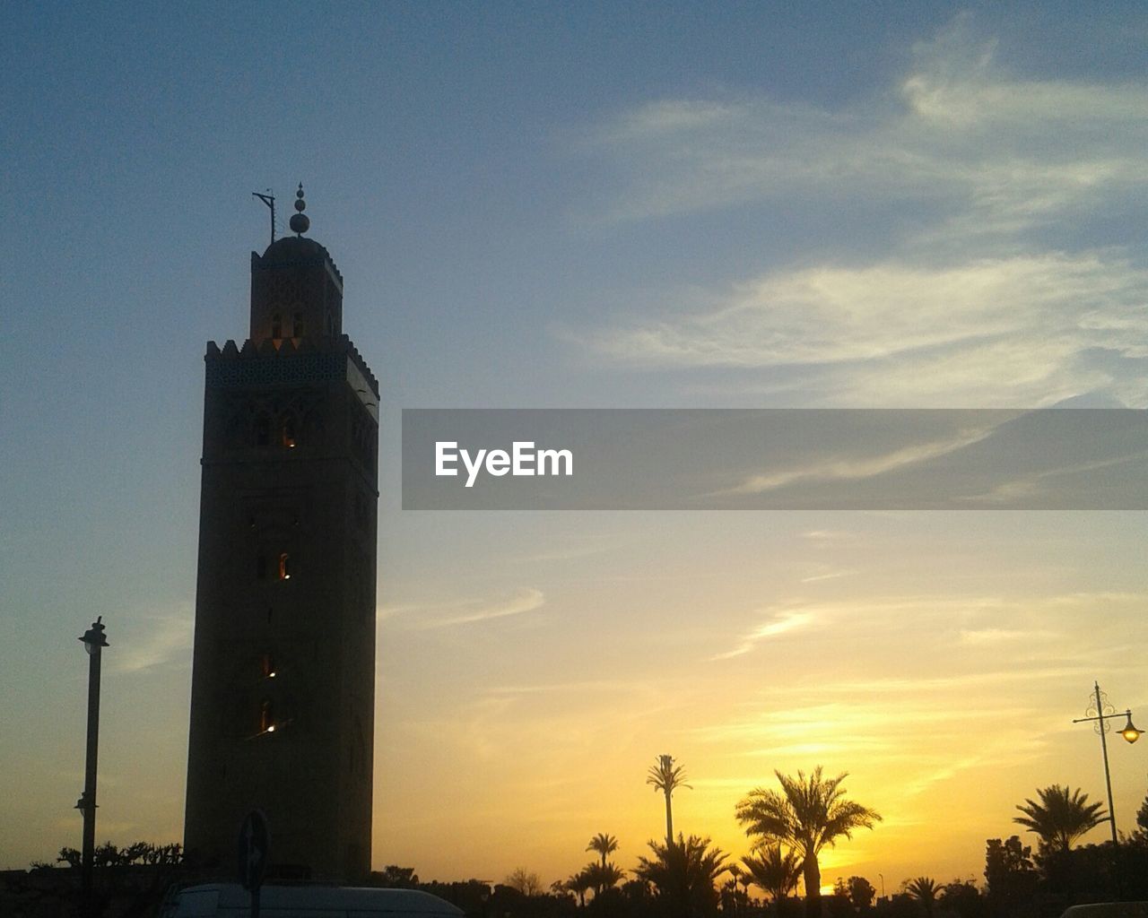 LOW ANGLE VIEW OF TOWER AT SUNSET