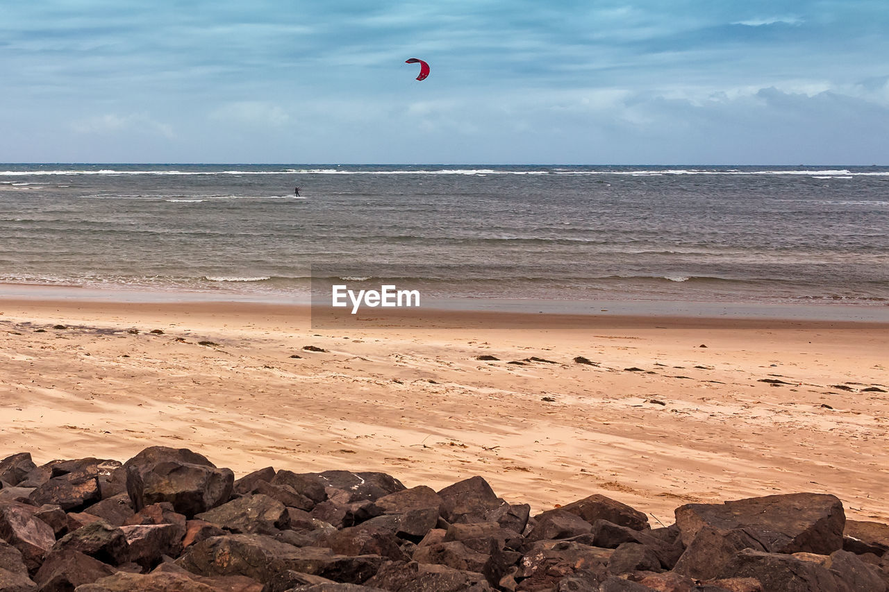 VIEW OF ROCKS ON BEACH AGAINST SKY