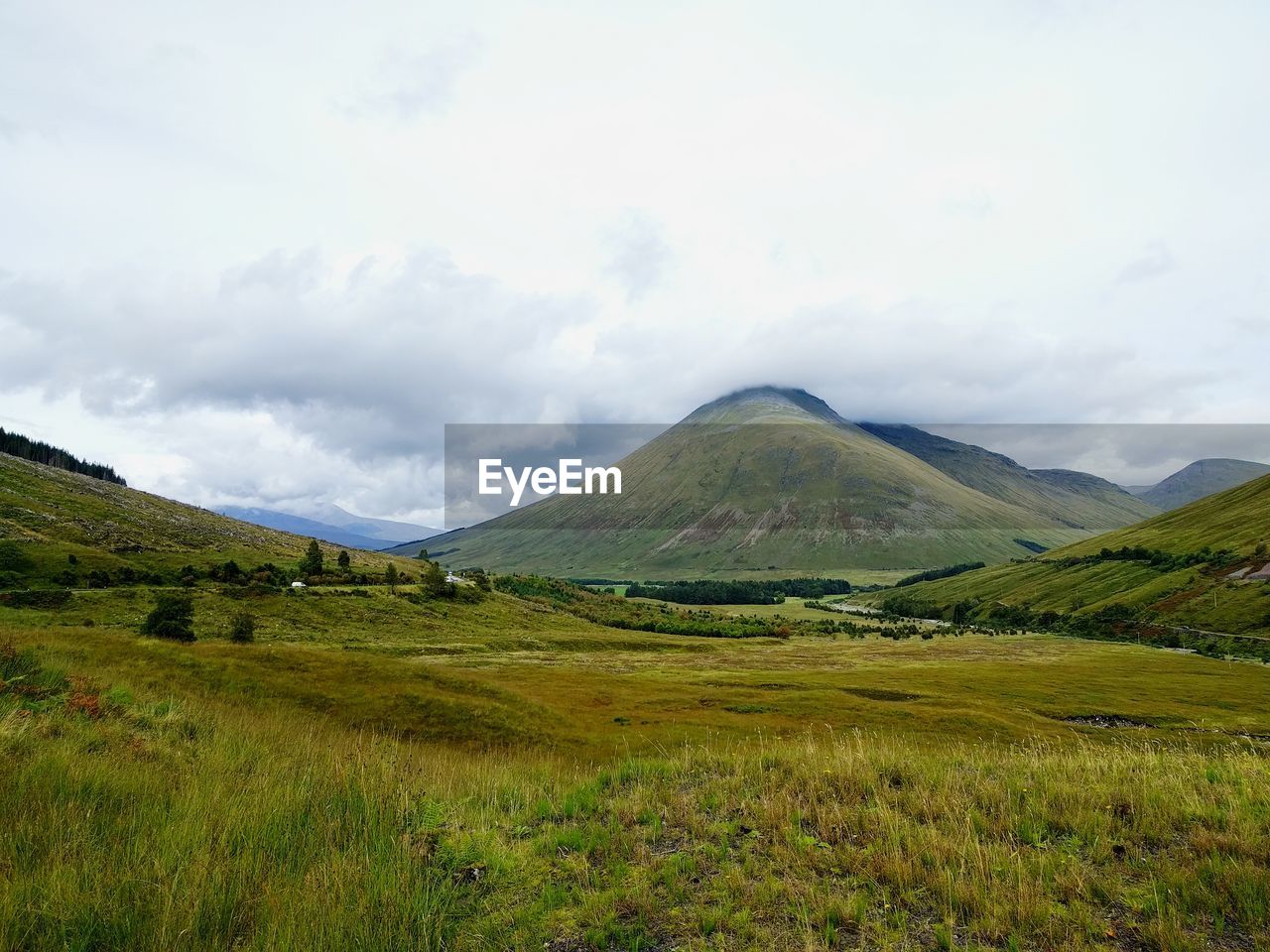 Scenic view of mountains against cloudy sky