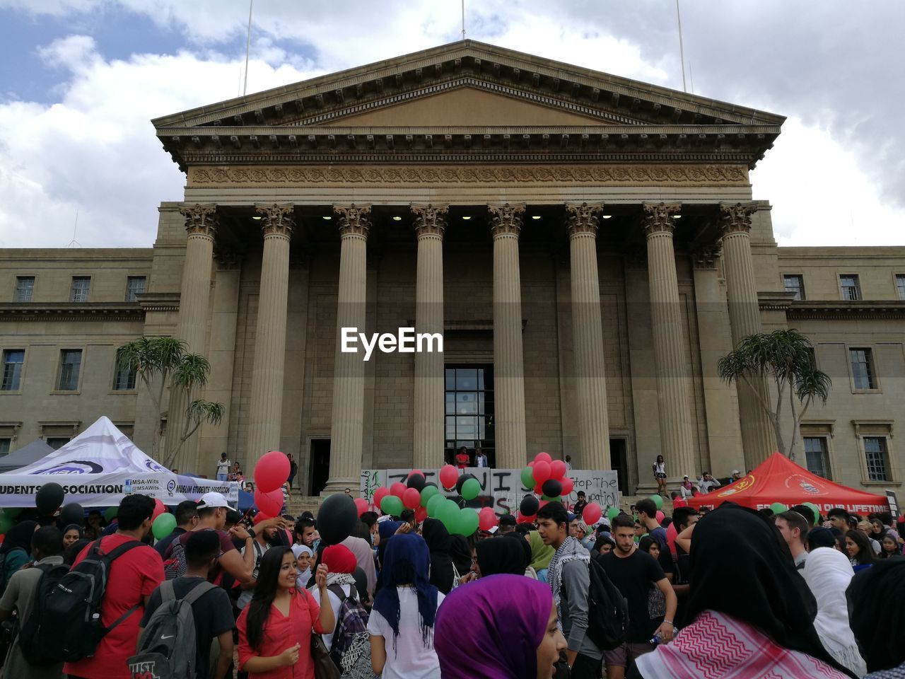 PEOPLE AT TOWN SQUARE AGAINST SKY