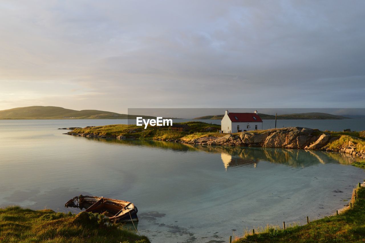 Scenic view of sea and houses against sky