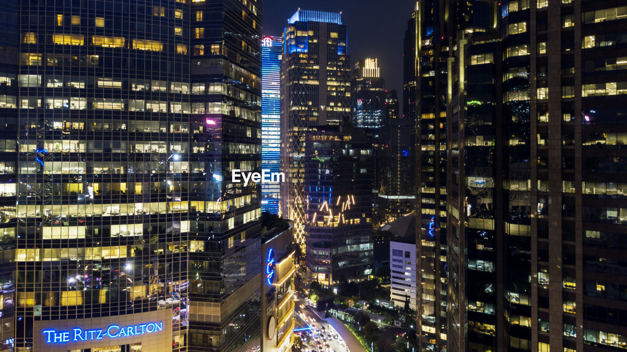 Aerial view of illuminated buildings in city at night