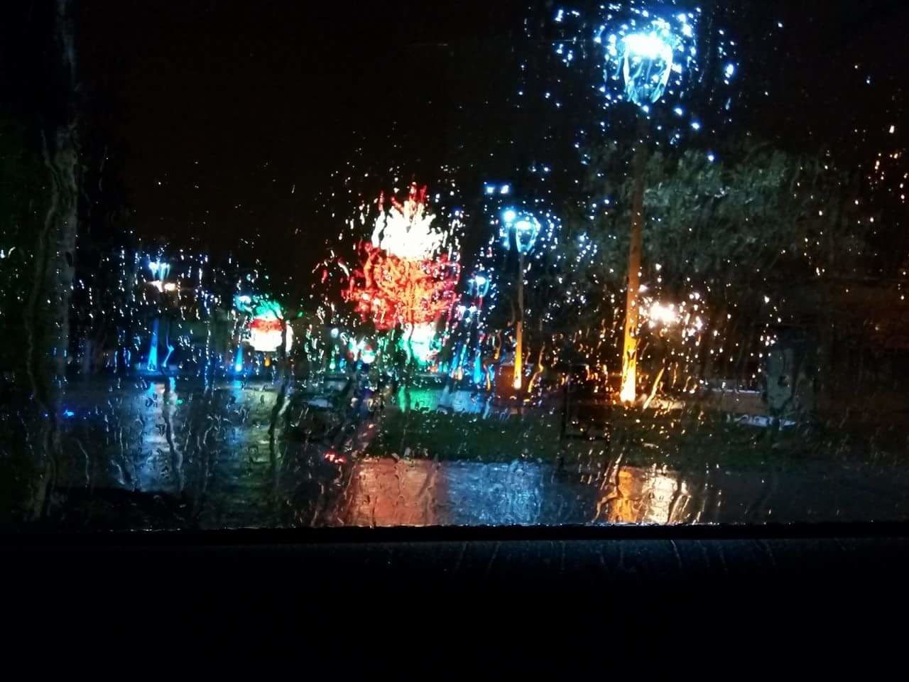 CLOSE-UP OF WET CAR WINDOW IN RAIN