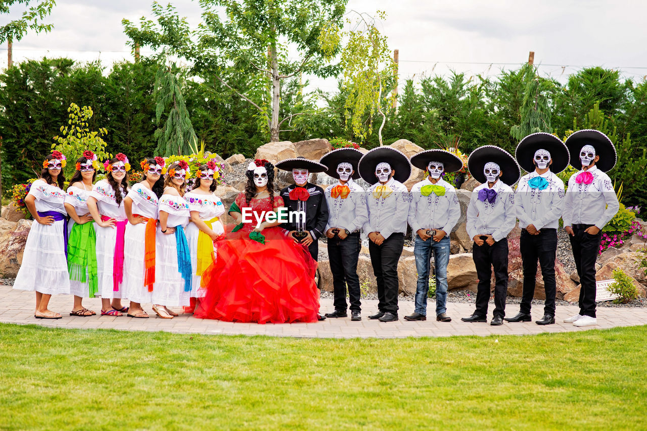 GROUP OF PEOPLE STANDING BY TREE