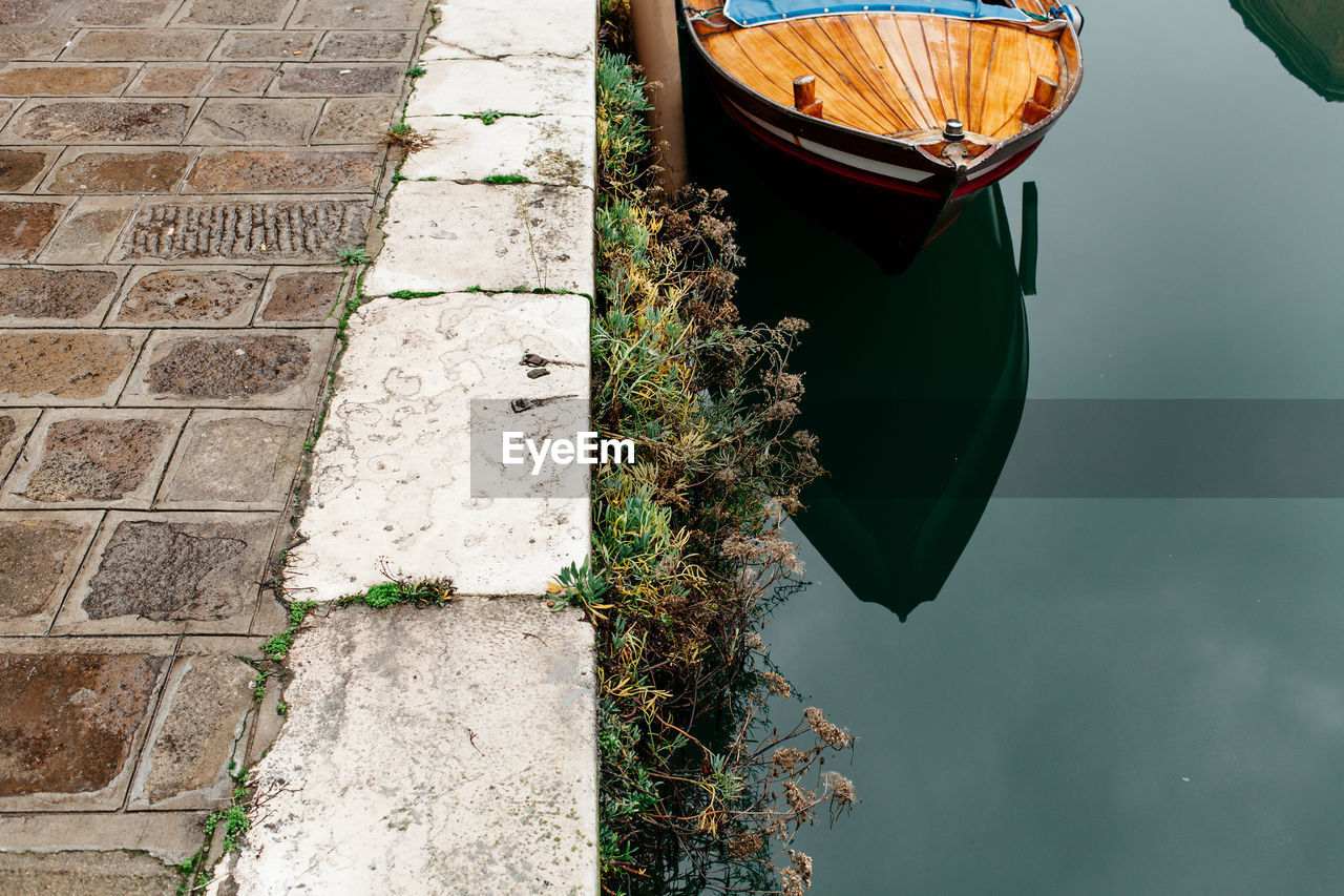 High angle view of boat in canal by footpath