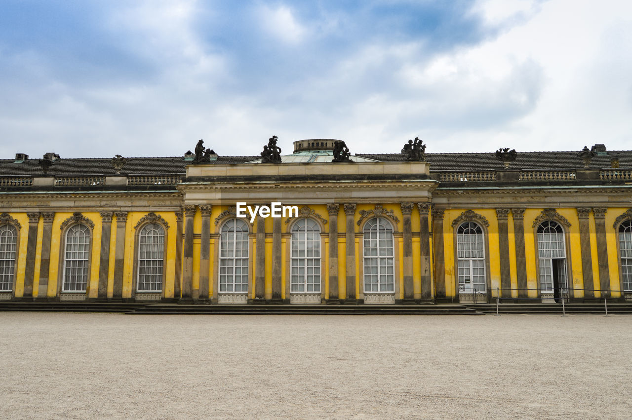 Low angle view of building against cloudy sky