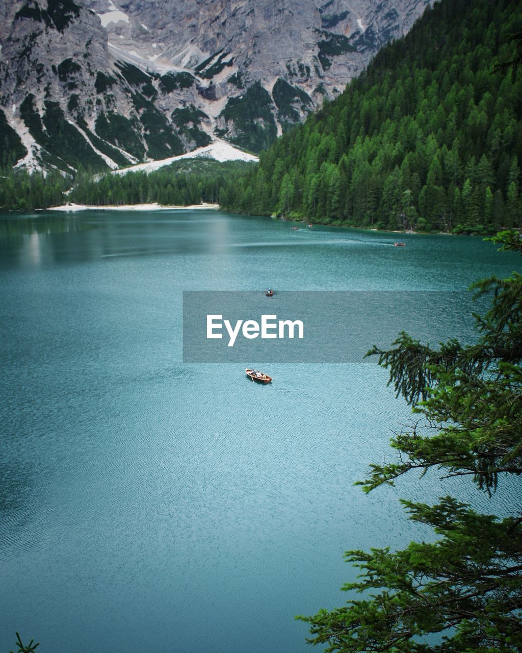 High angle view of boats on braies lake against mountains