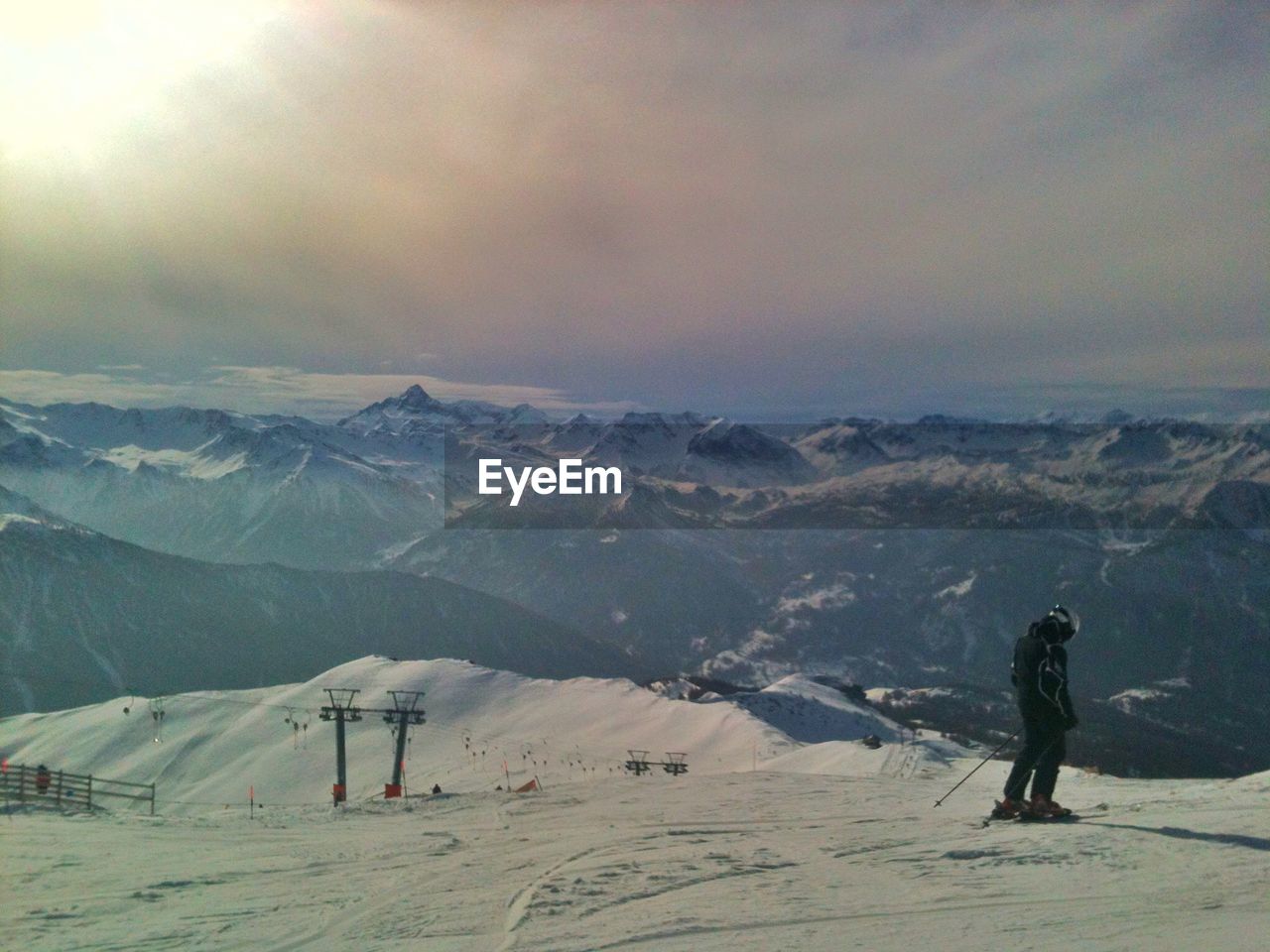 PEOPLE WALKING ON SNOWCAPPED MOUNTAIN AGAINST SKY