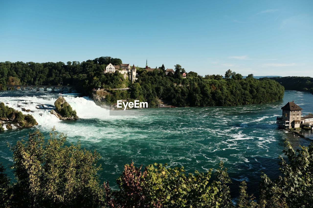 SCENIC VIEW OF WATERFALL AGAINST CLEAR SKY