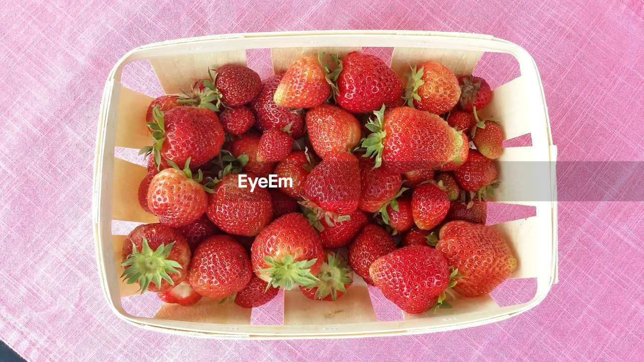 Directly above shot of strawberries on container on table