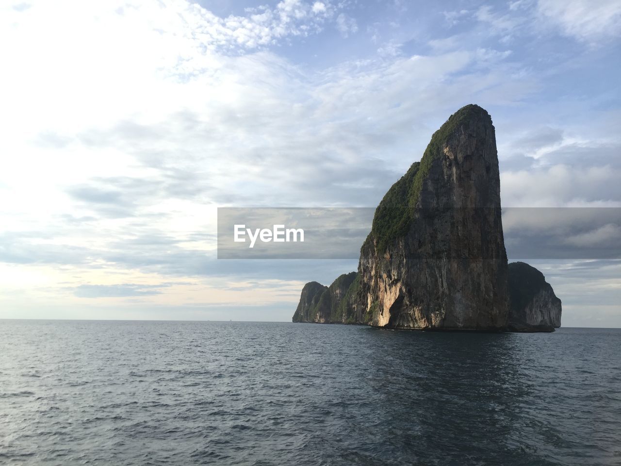 Rock formation in sea against sky