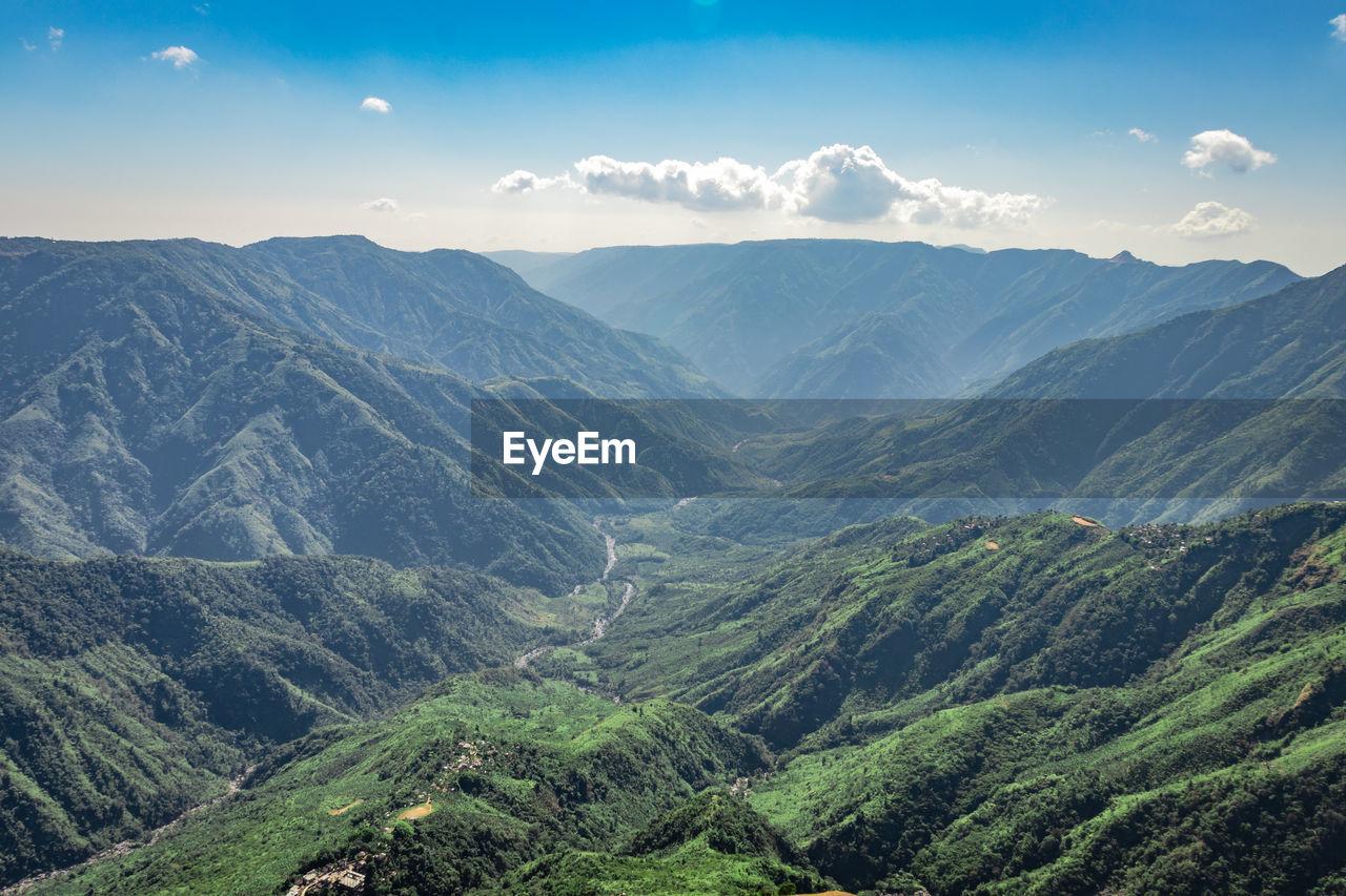 Misty mountain range covered with white mist and amazing blue sky