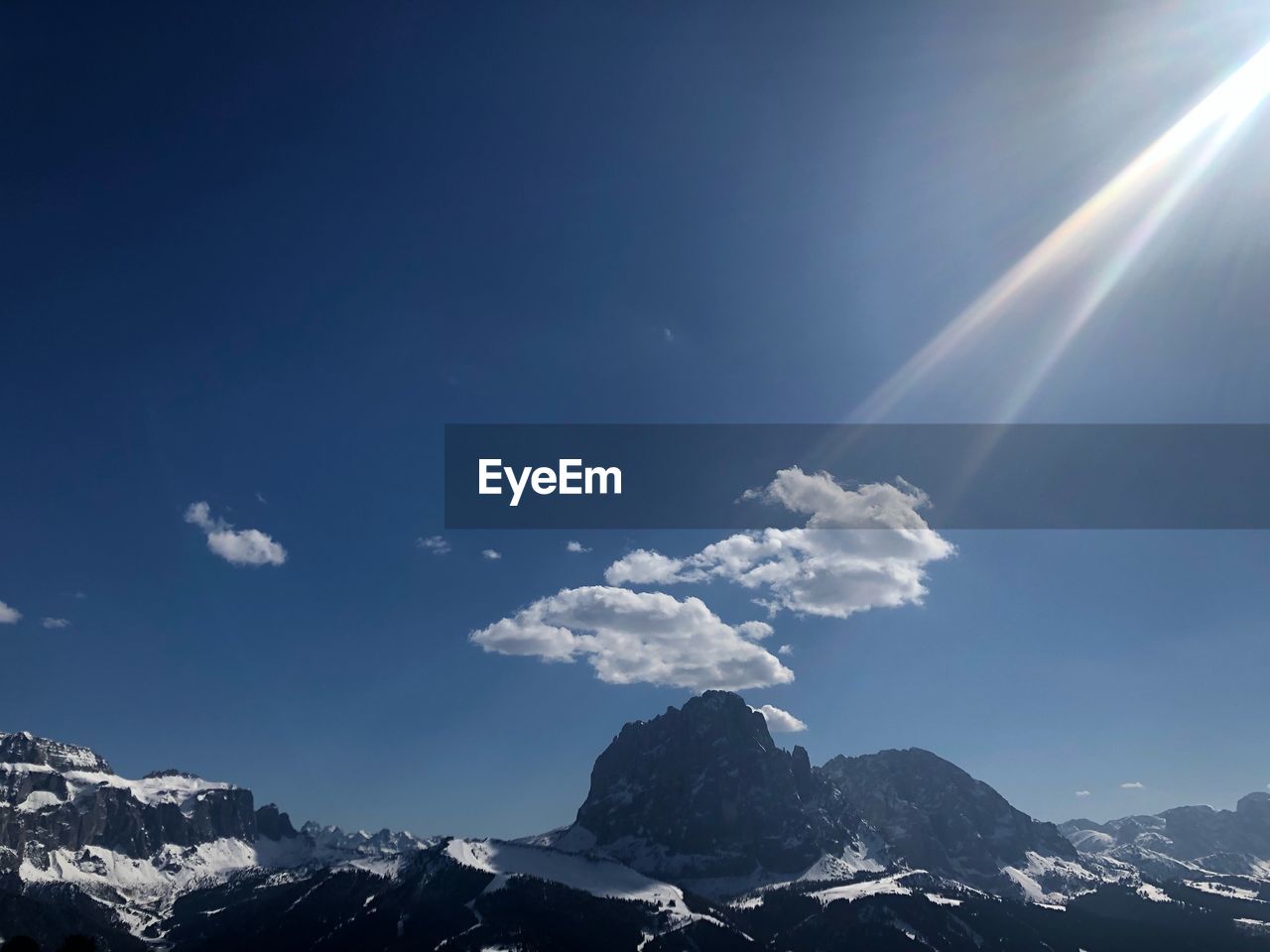 Low angle view of snowcapped mountains against sky