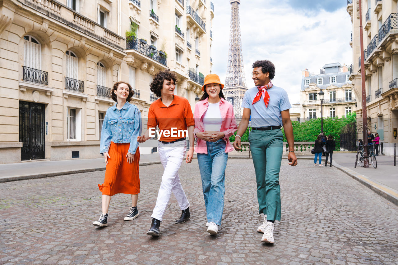 side view of friends walking on street