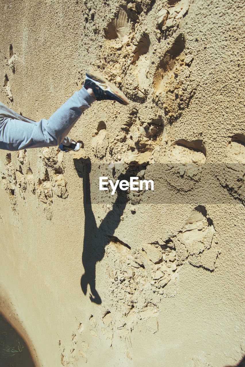 LOW SECTION OF MAN ON SAND