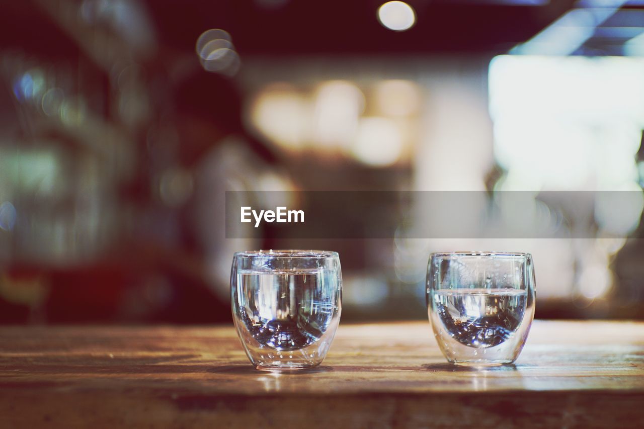 Close-up of two glasses on table