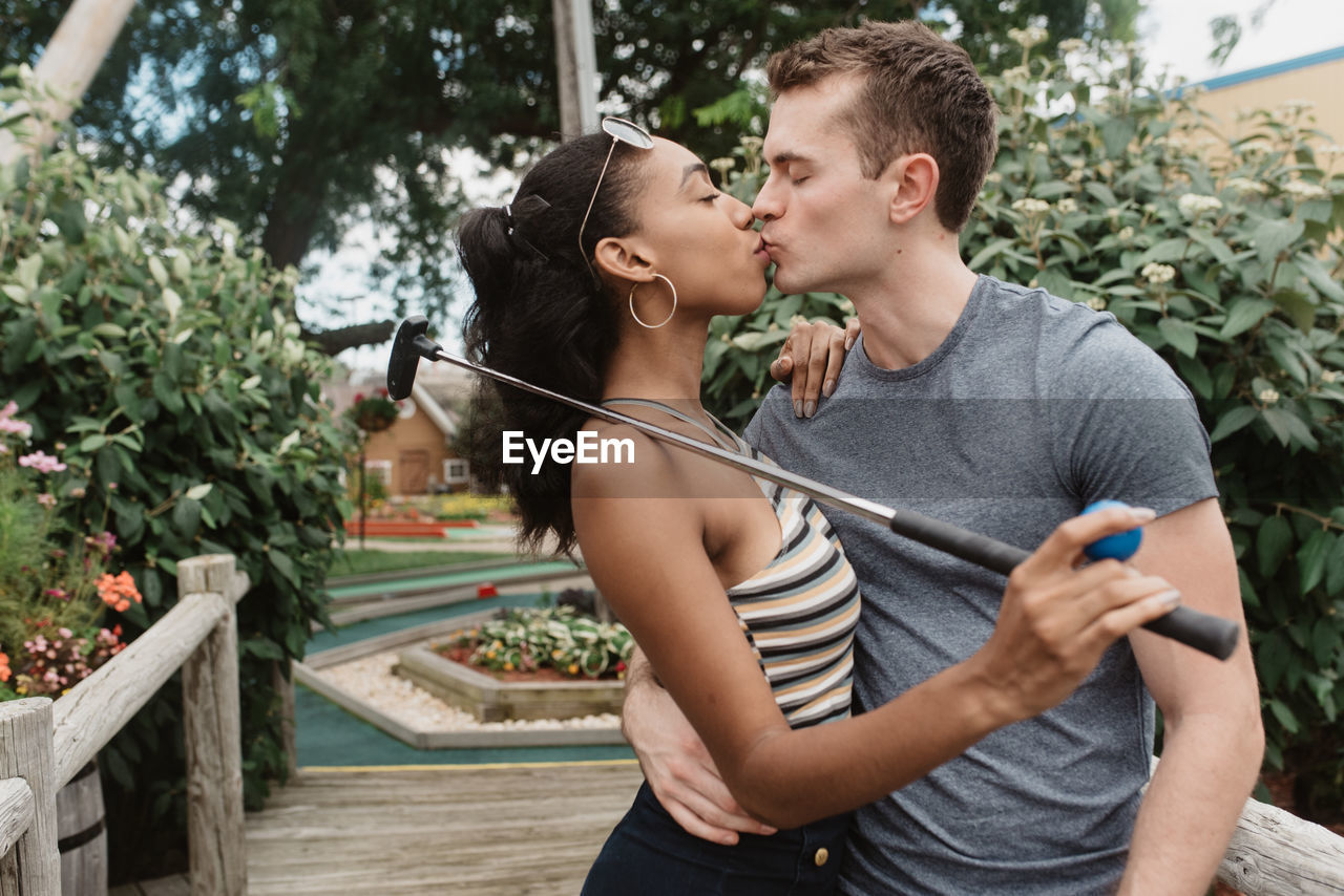 Young couple kissing in park