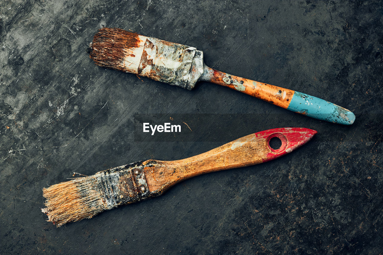 Paintbrushes on metal surface. old brush set for house maintenance. technical background