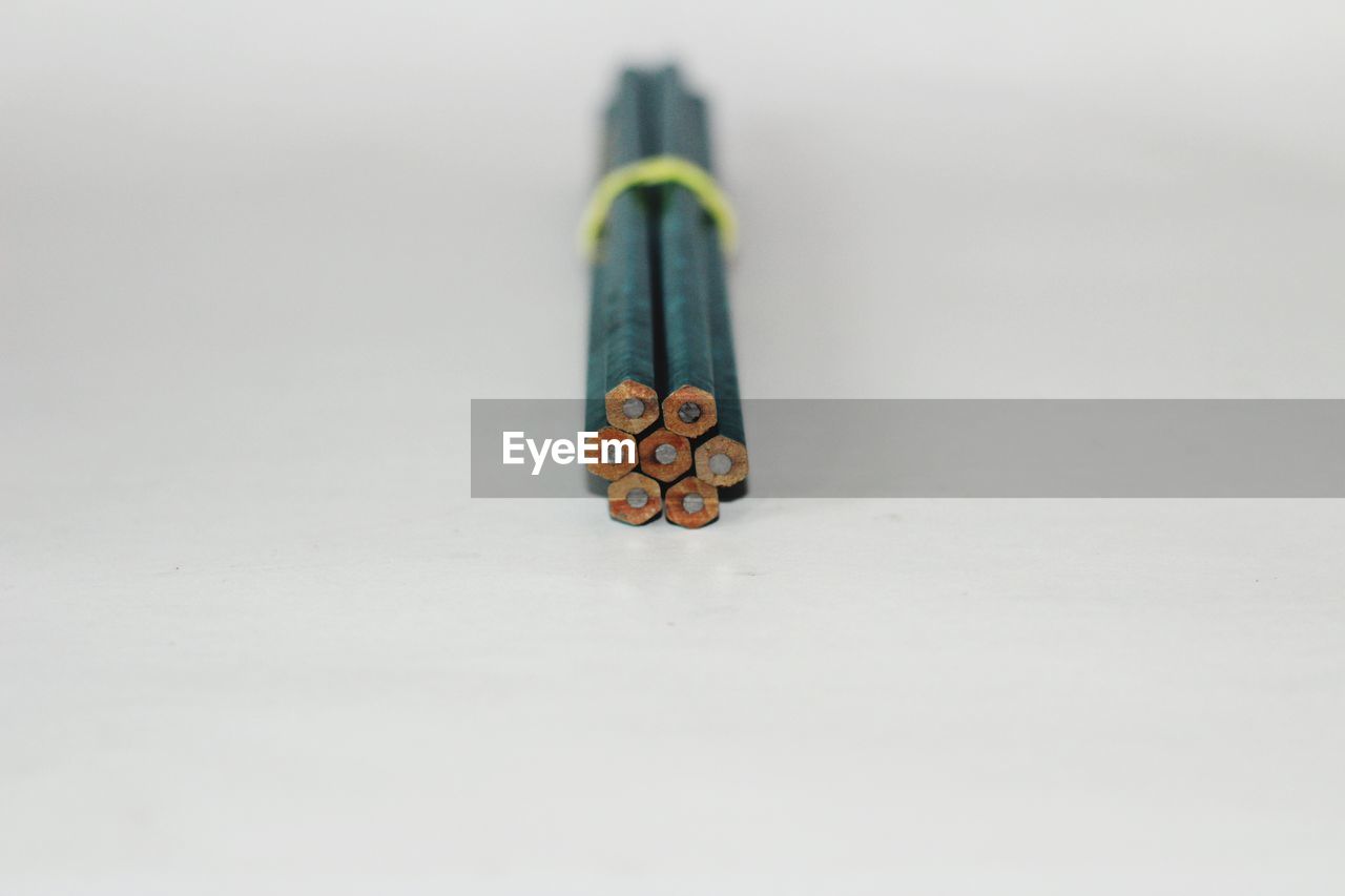 pencil, hand, indoors, white background, studio shot, still life, copy space, close-up, writing instrument, creativity