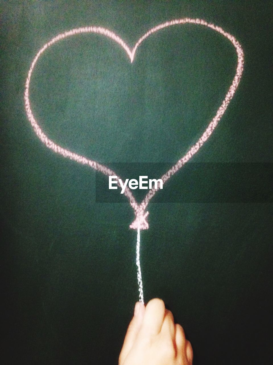 Heart shape drawing on blackboard