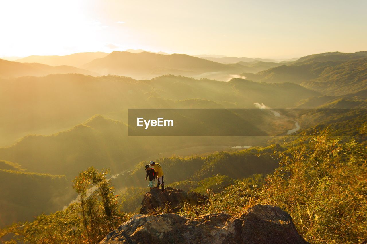 High angle view of people on mountains during sunset