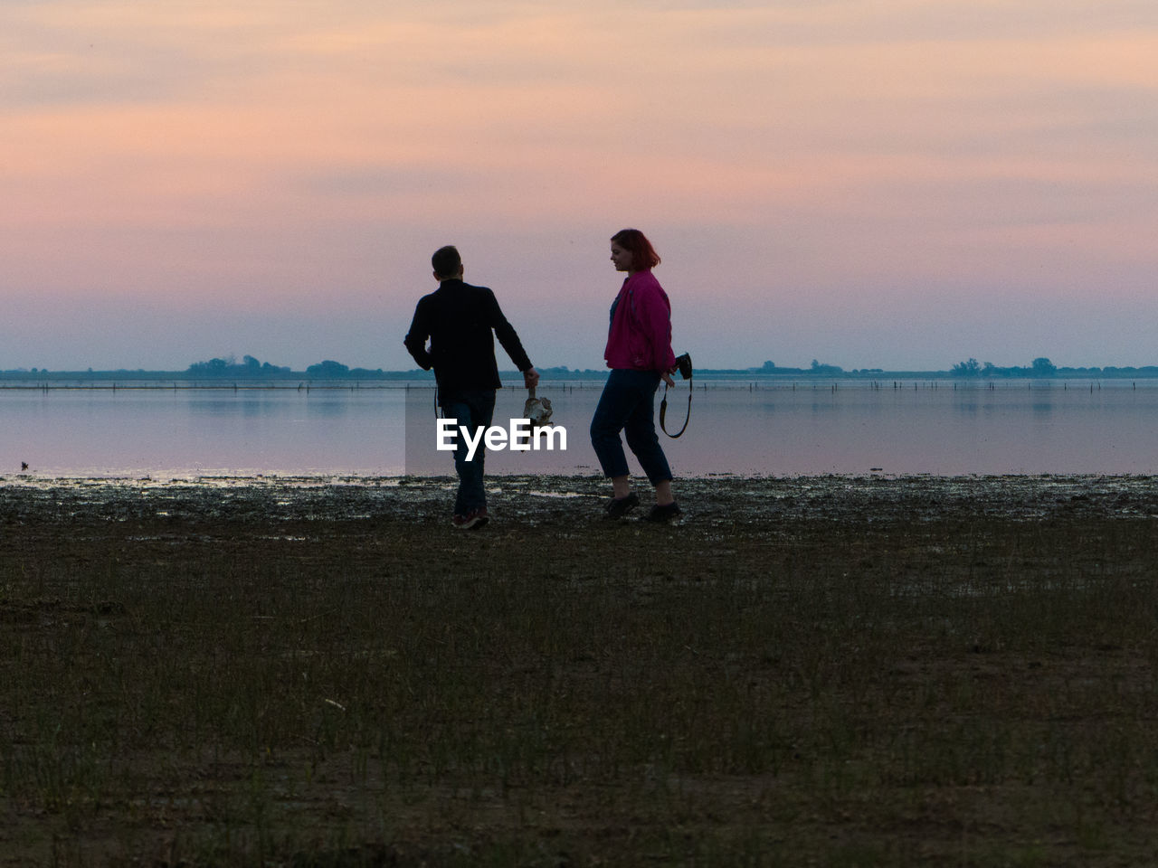 Couple taking pictures near the sea