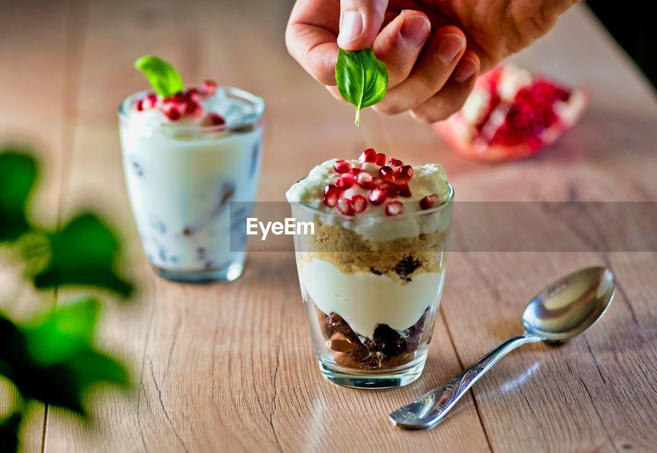 MIDSECTION OF ICE CREAM WITH GLASS OF JUICE