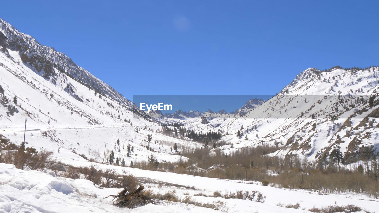 SNOW COVERED MOUNTAIN AGAINST CLEAR BLUE SKY