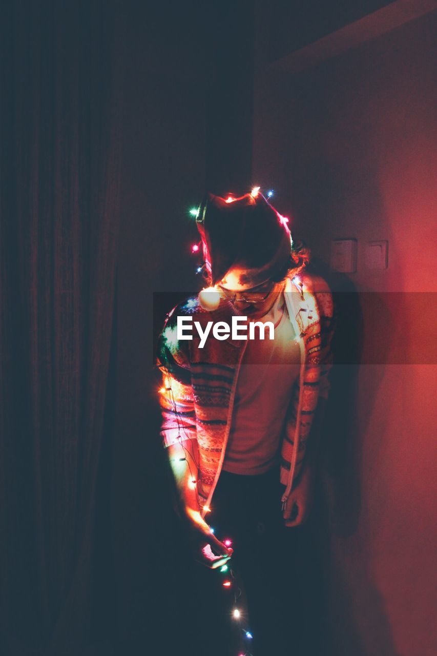 Man posing with christmas lights at home