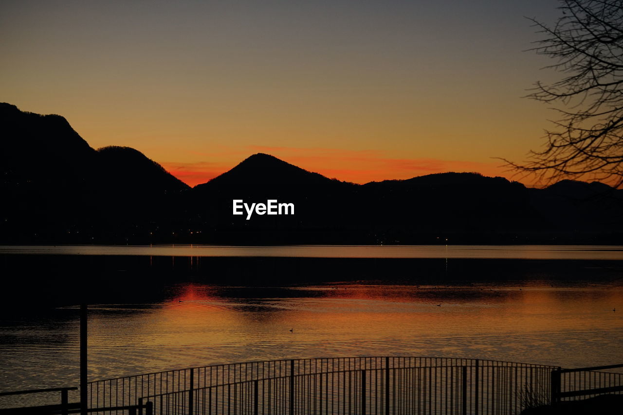 SILHOUETTE MOUNTAINS AGAINST SKY AT SUNSET