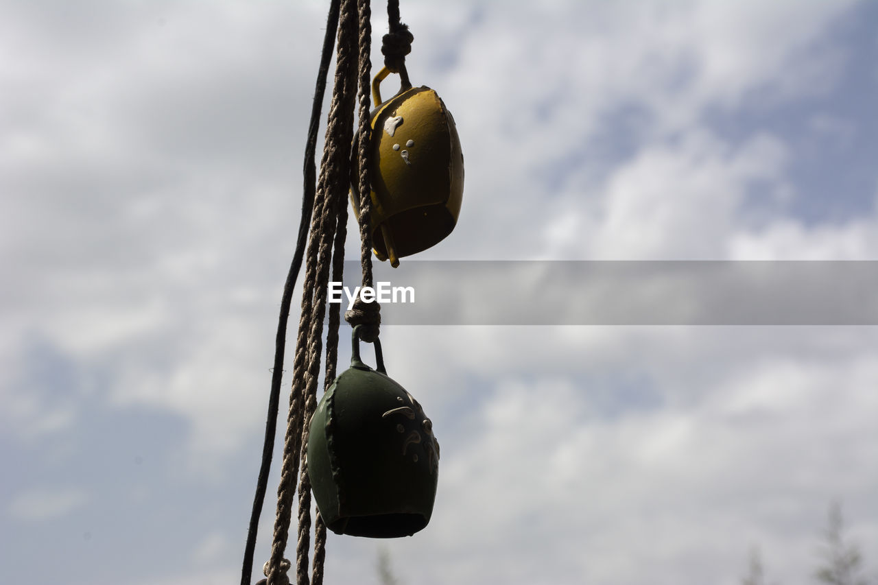 LOW ANGLE VIEW OF ROPES HANGING AGAINST SKY