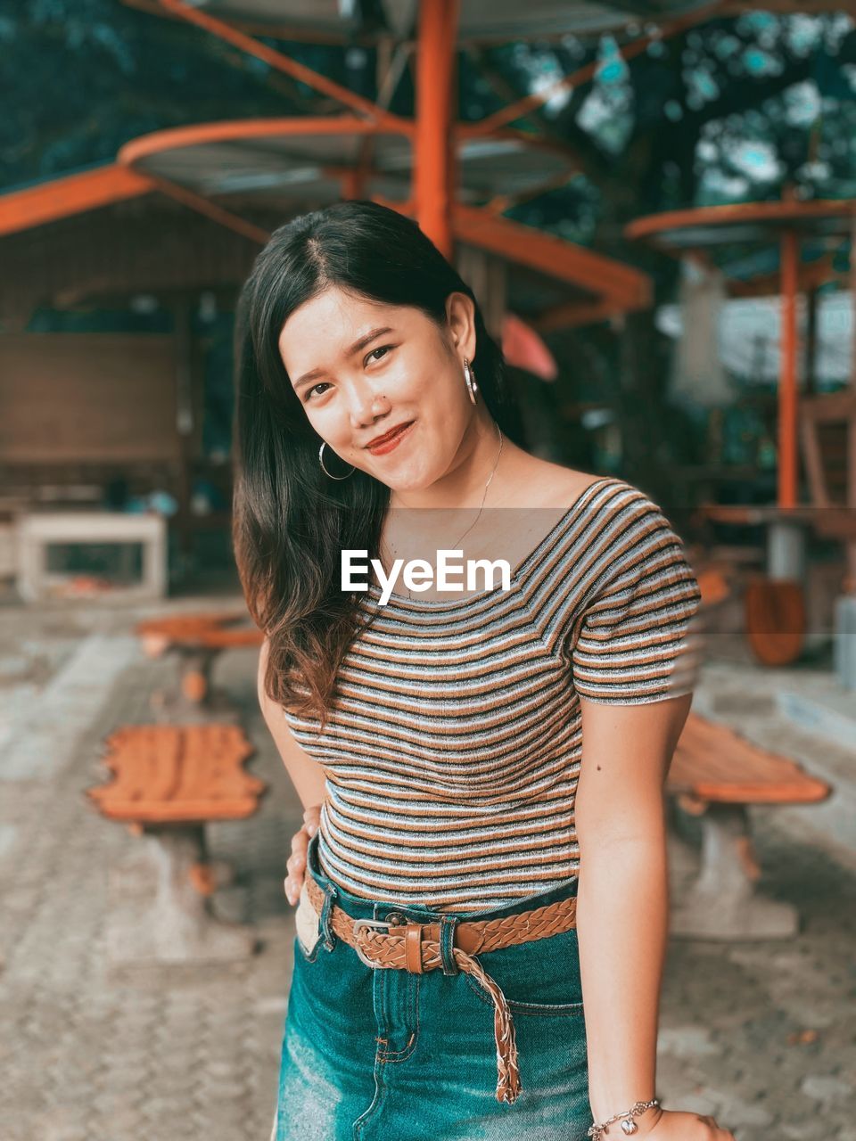 Portrait of smiling young woman standing outdoors