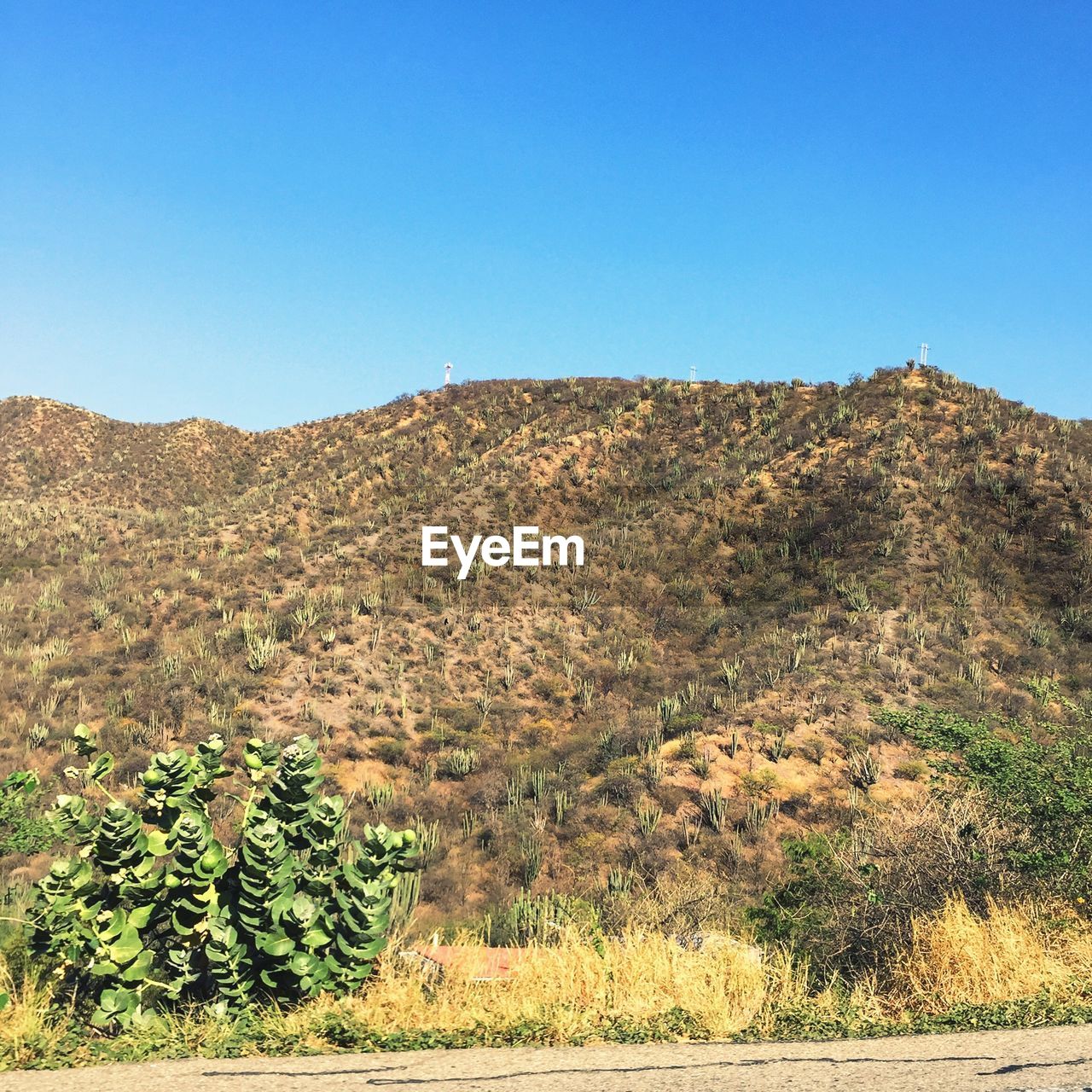 Scenic view of land against clear blue sky