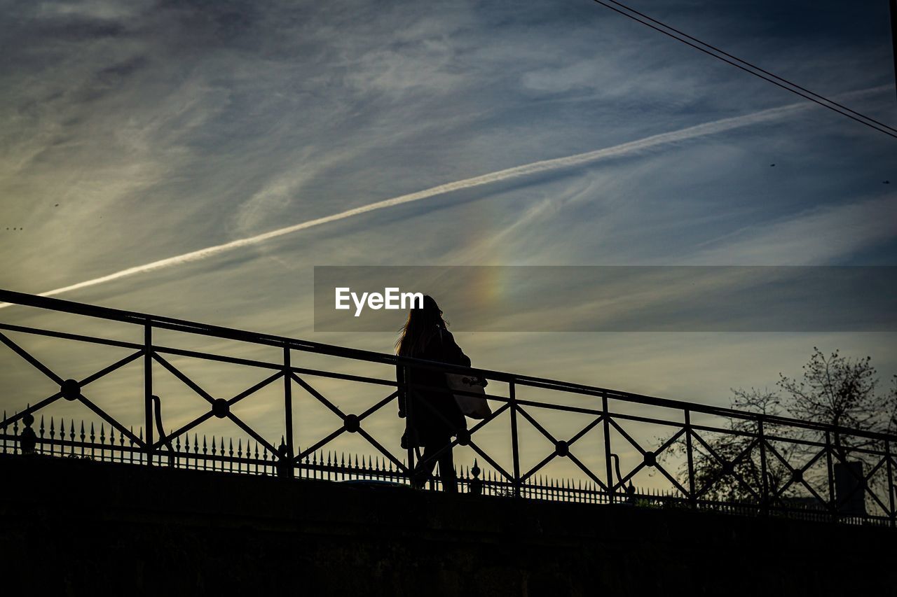 Low angle view of silhouette bridge against sky at sunset