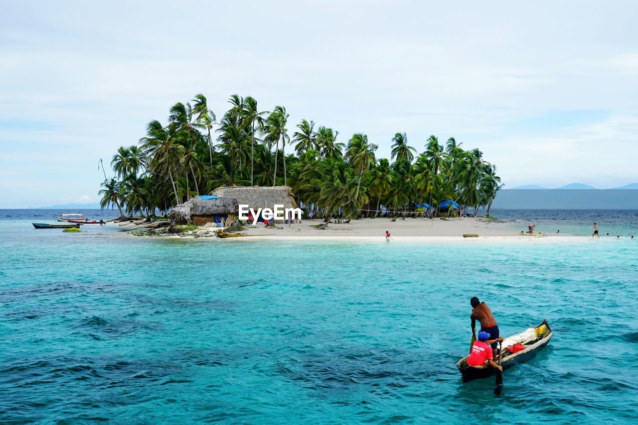 Man and woman in boat at beach