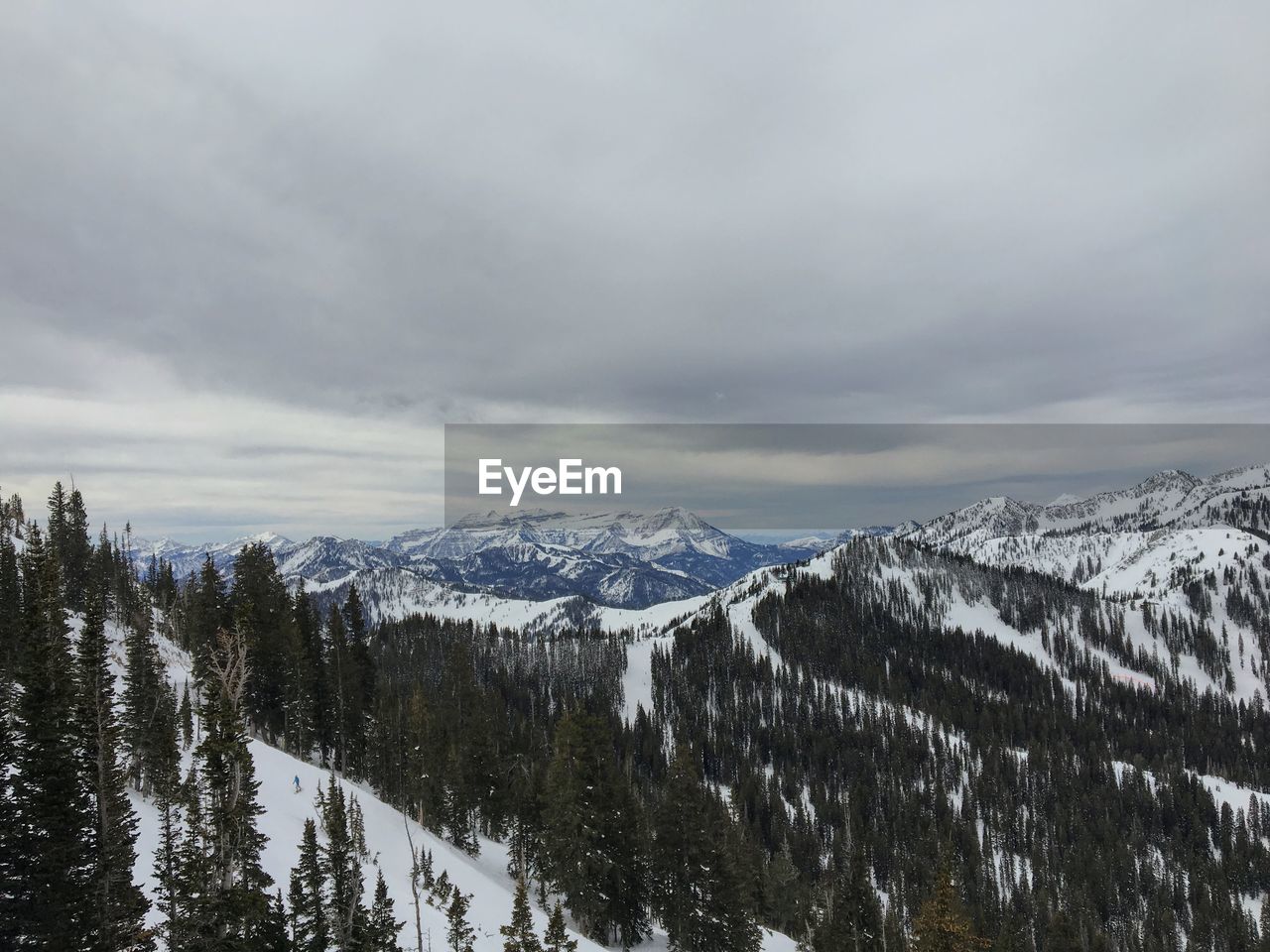 SNOW COVERED MOUNTAINS AGAINST SKY