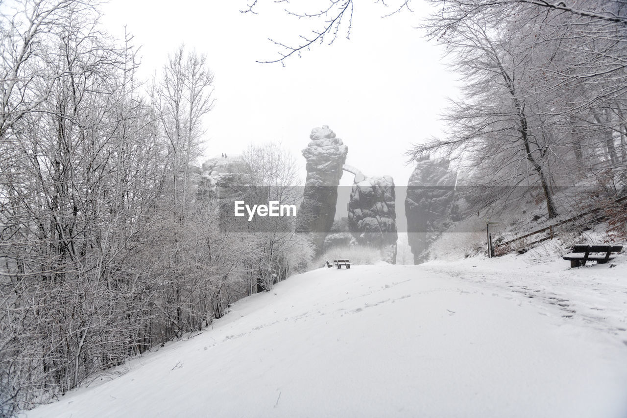 Snow covered landscape against sky