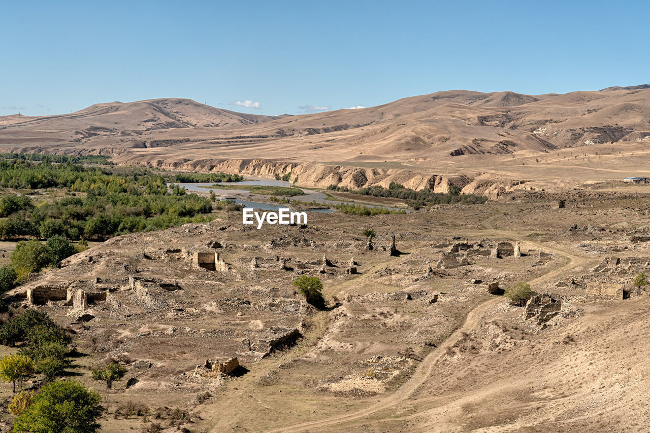 Scenic view of desert against clear sky