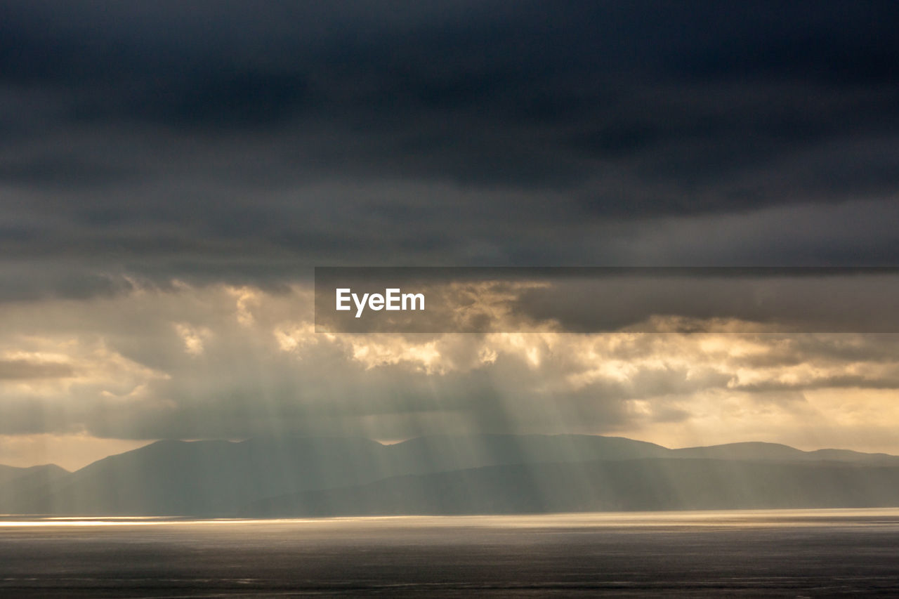 Scenic view of sea against storm clouds