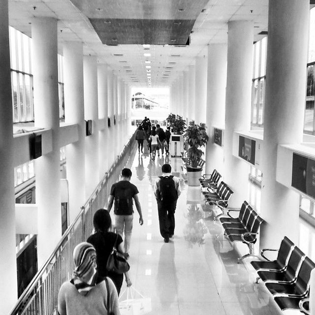 WOMAN WALKING IN CORRIDOR