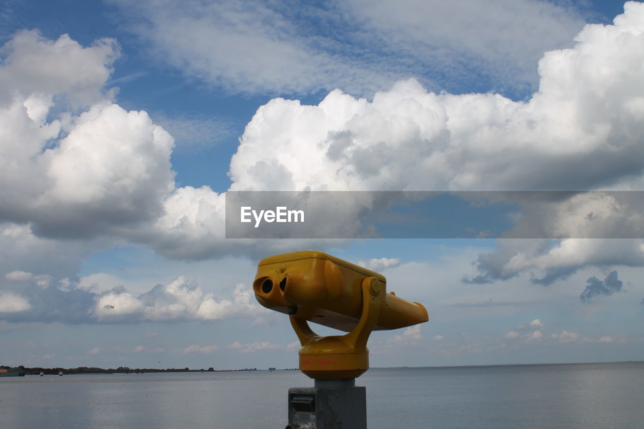 COIN-OPERATED BINOCULARS BY SEA AGAINST SKY