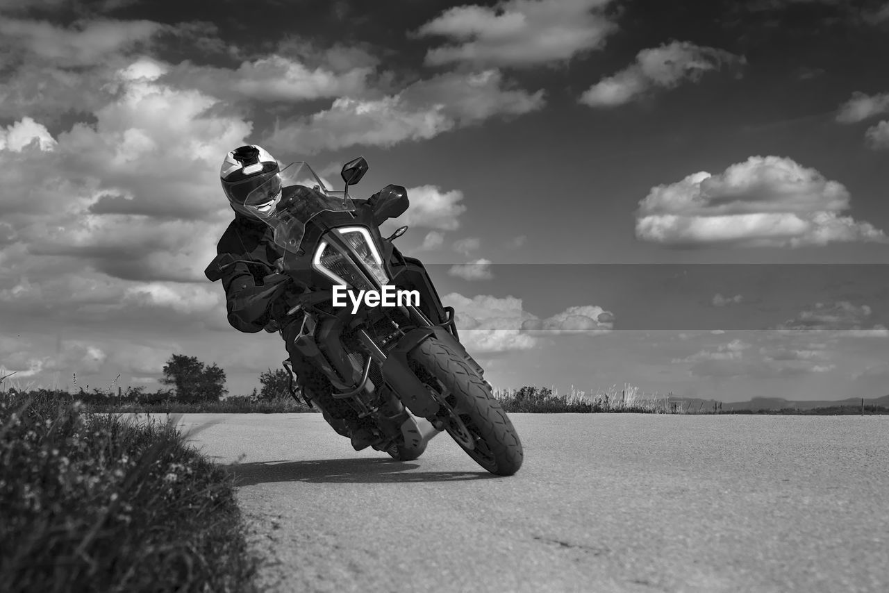 Low angle view of man on motorcycle against sky