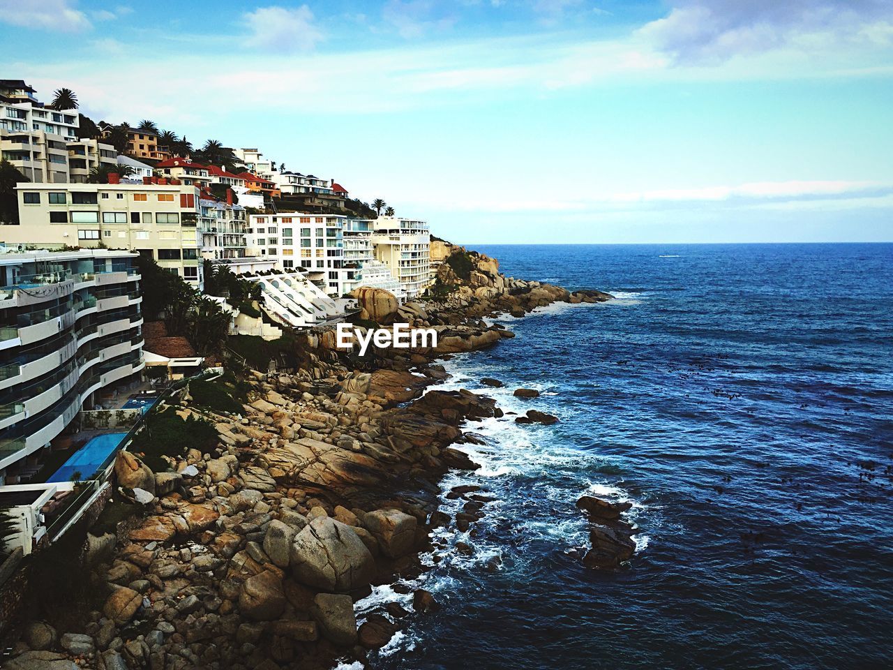 Cityscape by bantry bay against sky